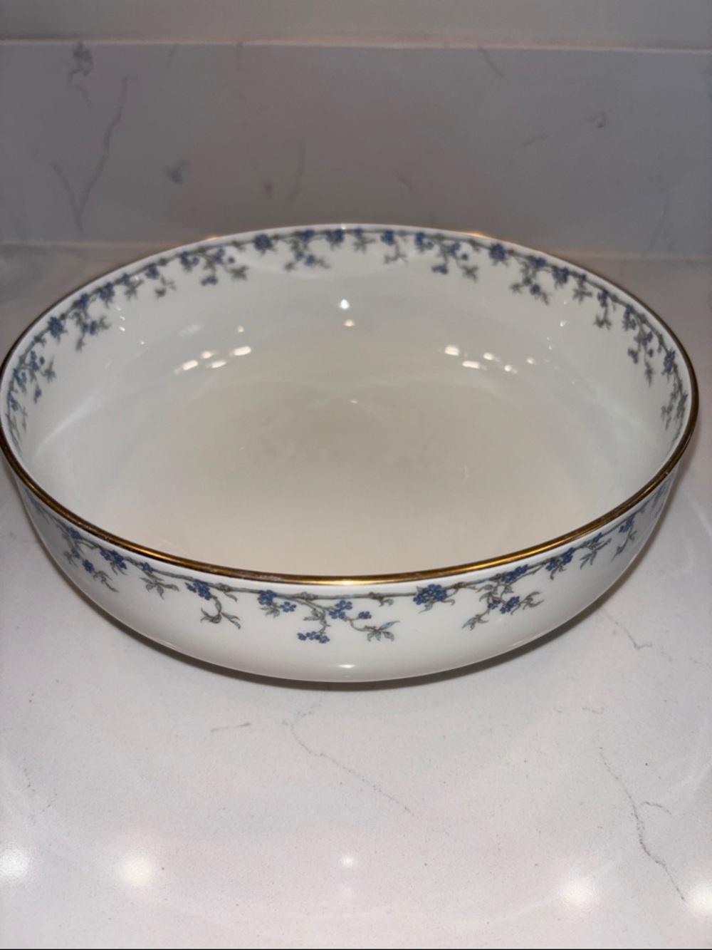 White Porcelain Serving Bowl with Blue Floral Motif and Gold Accen